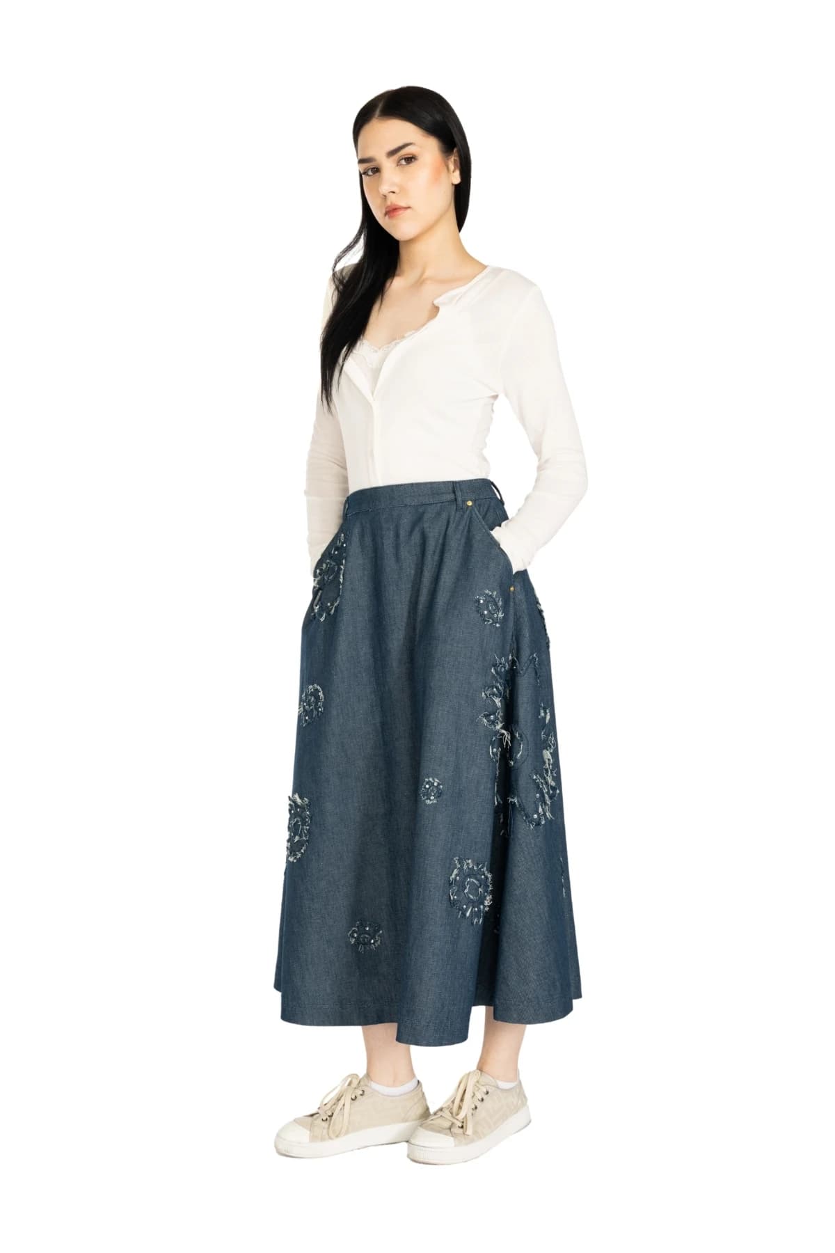 Denim Moon women's dark indigo midi A-line denim skirt with floral appliqué details, full-length side view on model.
