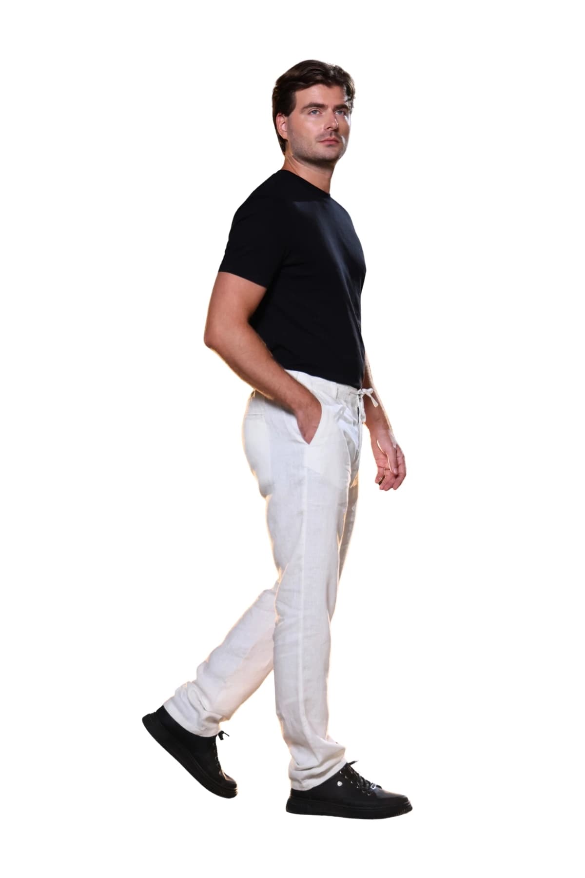 Denim Moon men's white linen trousers with drawstring waist detail, side view on model.