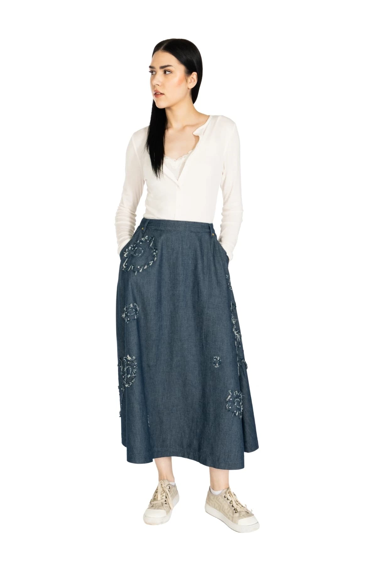 Denim Moon women's dark indigo midi A-line denim skirt with side pockets and full hem, full-length three-quarter front view on model.