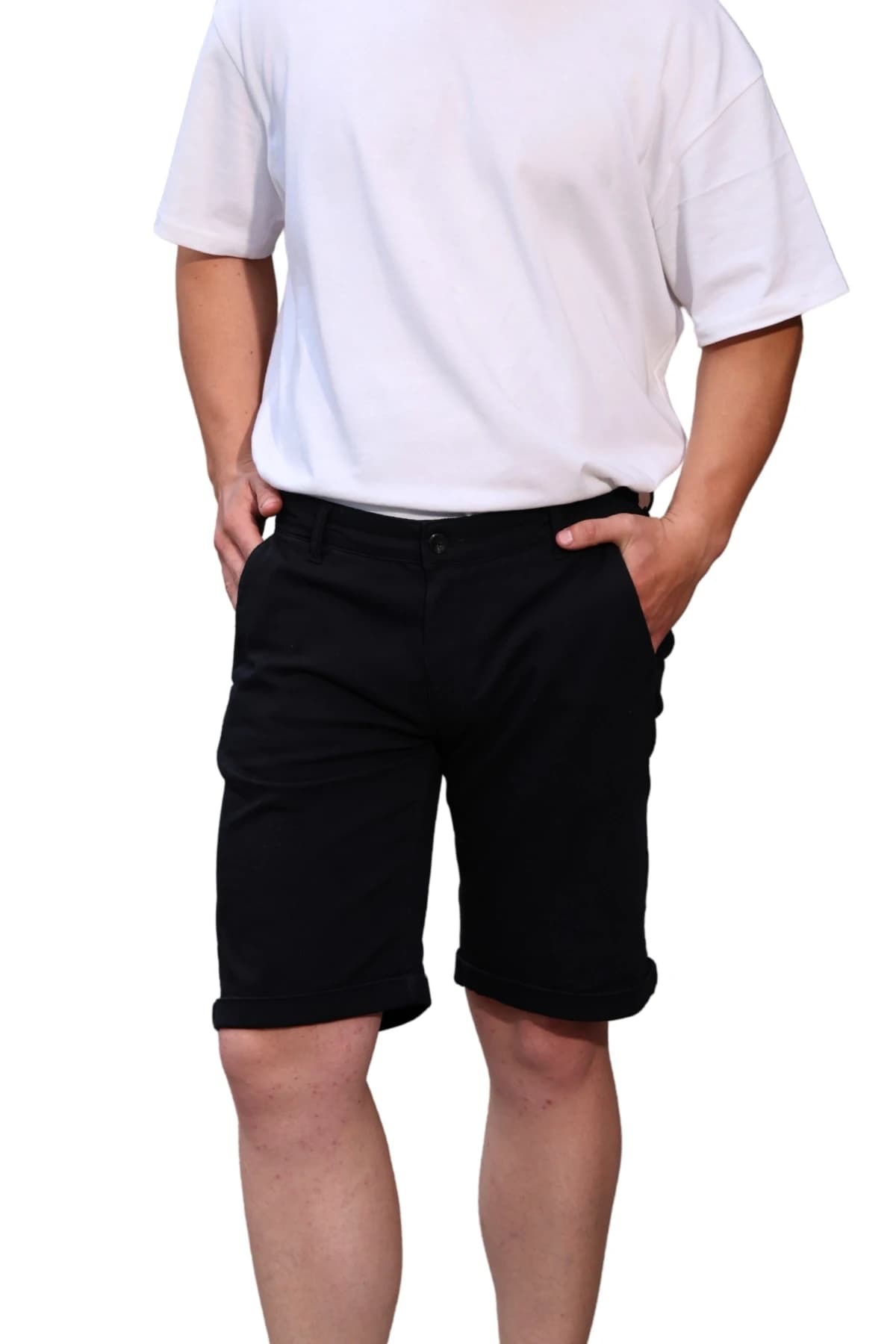 Denim Moon men's black woven chino shorts with side pocket and rolled hem detail, close-up front view on model.